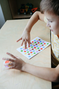 High angle view of girl drawing on table