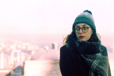 Young woman standing against sky during winter