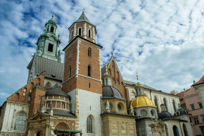 Low angle view of wawel cathedral against cloudy sky