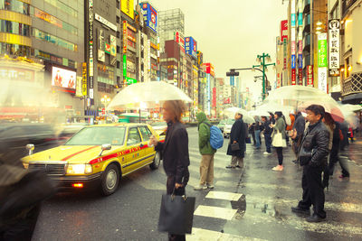 People walking on road in rain