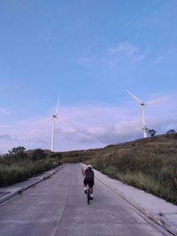 People walking on road against sky
