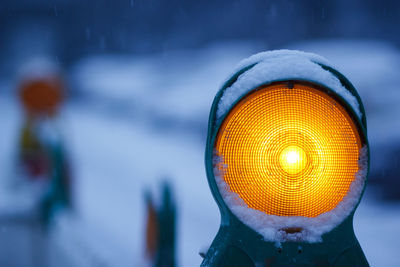 Close-up of illuminated lighting equipment in winter