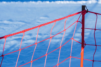 Close-up of red zone against sky