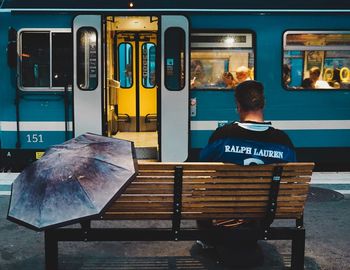 Rear view of man sitting in train