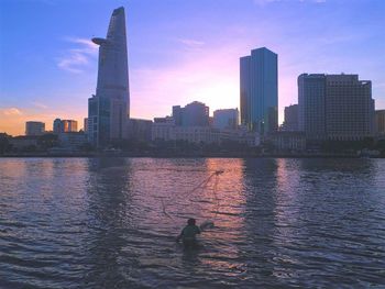 Silhouette of city at waterfront
