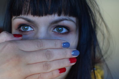 Close-up portrait of woman with hand