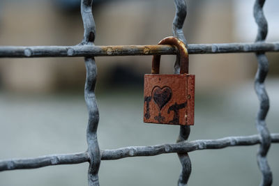 Close-up of padlock on fence