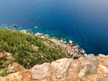 High angle view of rocks by sea