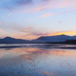 Scenic view of lake at sunset