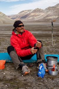 Mature man sitting in mountains