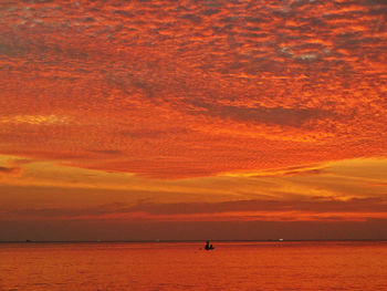 Scenic view of sea against orange sky