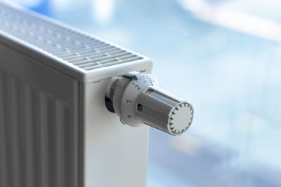 Close-up of mobile phone against sky