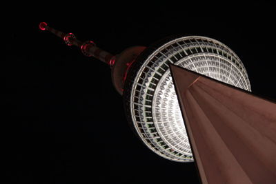 Low angle view of illuminated ferris wheel at night