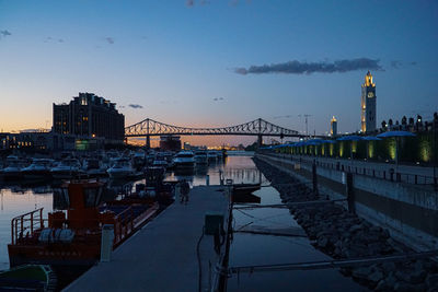 View of bridge over river at dusk