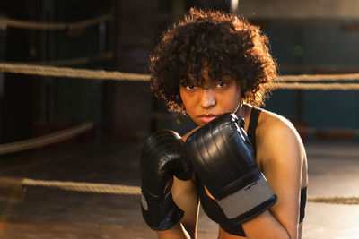 Portrait of young woman exercising in gym