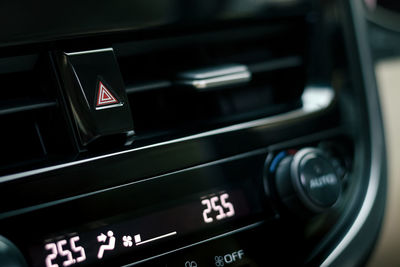 Close-up of car dashboard, hazard flasher switch or emergency light button in modern car