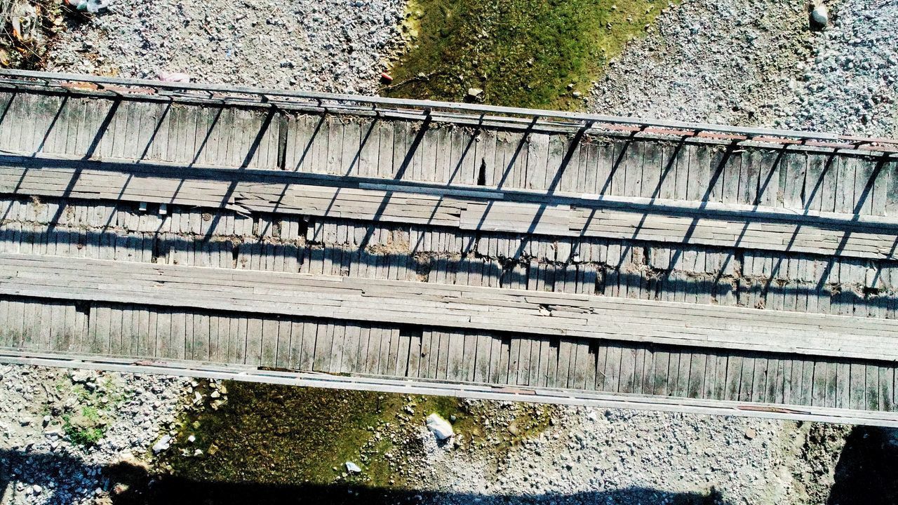 HIGH ANGLE VIEW OF BRIDGE BY CANAL