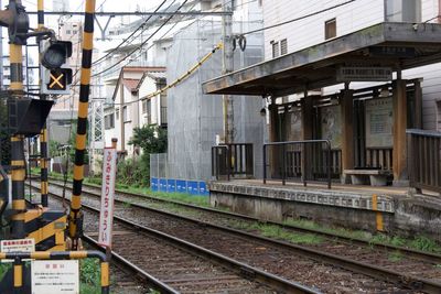 Railroad tracks amidst buildings in city