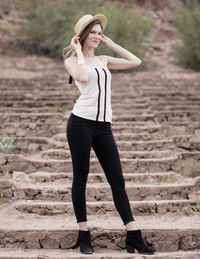 Full length of young woman looking at camera