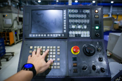 Cropped hands of woman using calculator