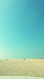 Scenic view of desert against clear blue sky