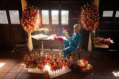 Woman sitting by flower bouquet