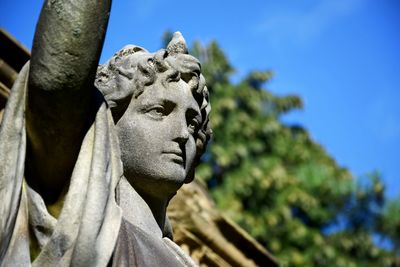 Low angle view of statue against clear blue sky