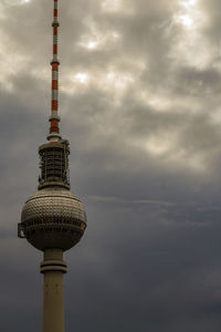 Low angle view of tower against cloudy sky