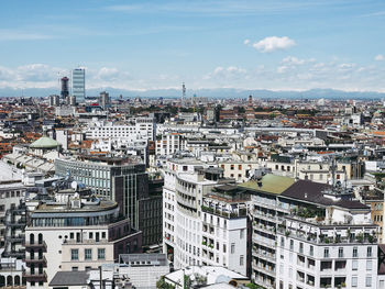 Aerial view of cityscape against sky during sunny day