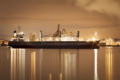 View of illuminated commercial dock against sky