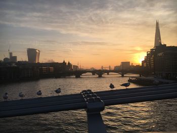 View of city at waterfront during sunset