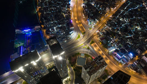 High angle view of city lit up at night