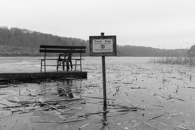 A jetty at the lake with a sign in front of it  no trespassing