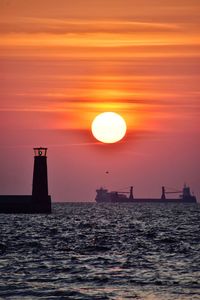 Scenic view of sea against orange sky