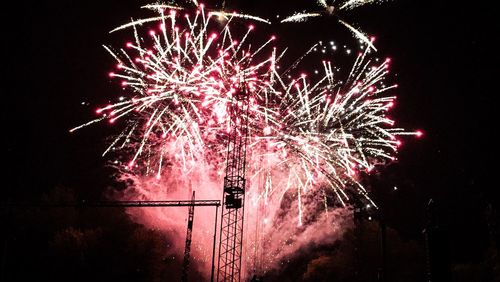 Low angle view of firework display at night