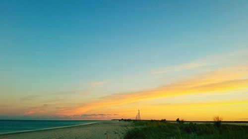 Scenic view of beach against sky during sunset