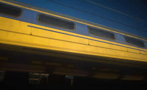 Low angle view of train against blue sky