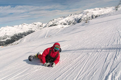 Snowboarder on snow covered mountain