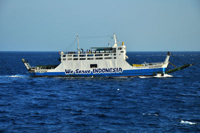 Ship sailing on sea against clear sky