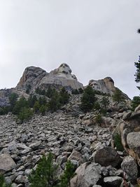 Low angle view of rock formations against sky