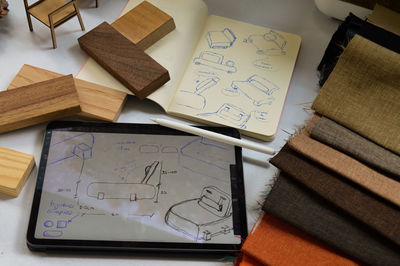 Furniture design, digital drawing in tablet and analog in notebook