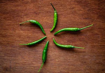 High angle view of green chili peppers on table