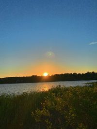 Scenic view of lake against sky during sunset