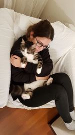High angle view of woman sitting on sofa at home