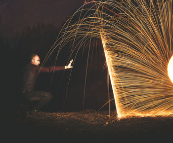 Low angle view of firework display at night