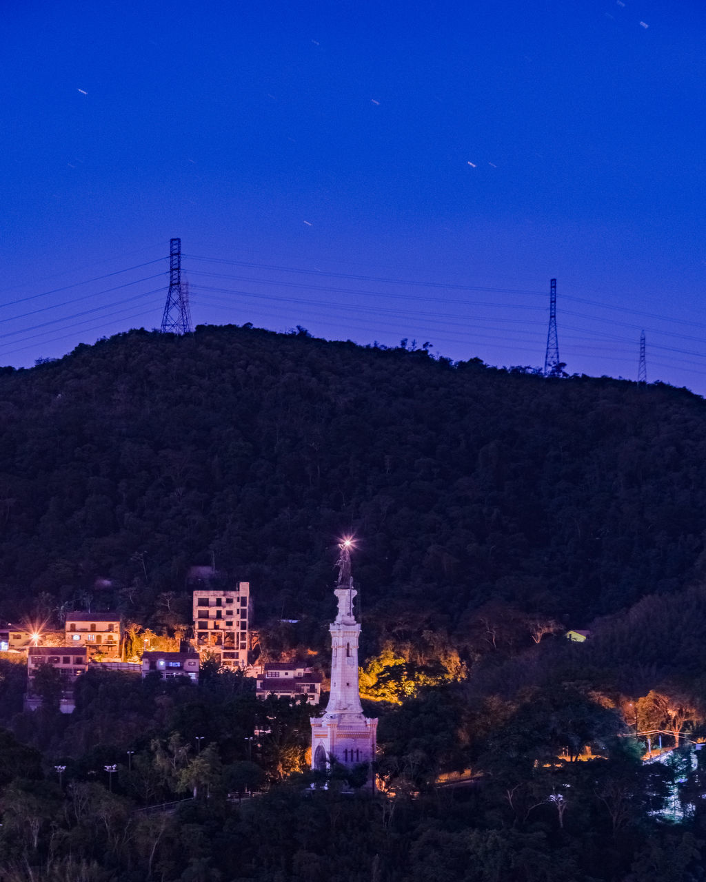 ILLUMINATED CITY AGAINST BLUE SKY