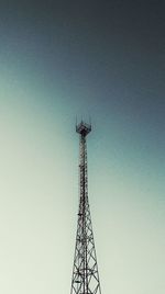 Low angle view of communications tower against clear blue sky