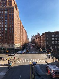 View of city street and buildings against sky