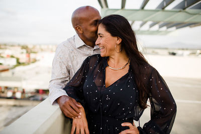 Midsection of couple standing outdoors