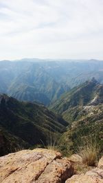 Scenic view of mountains against cloudy sky